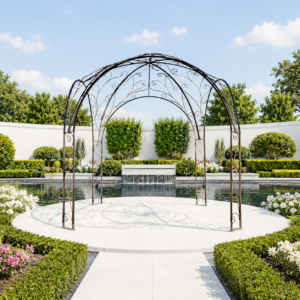 Wrought iron pergola in idyllic garden with a water feature.